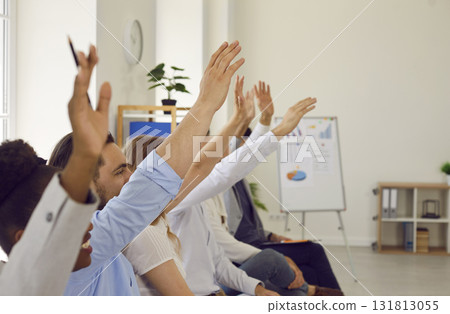 Audience raising their hands to ask questions at a business conference or seminar 131813055