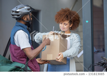Black man, box and customer signing in ecommerce for delivery service, package or order at door. Happy African American female with courier guy with signature on clipboard for quality or feedback Black man, box and customer signing in ecommerce for delivery service, package or order at door. Happy African American female with courier guy with signature on clipboard for quality or feedback 131813085