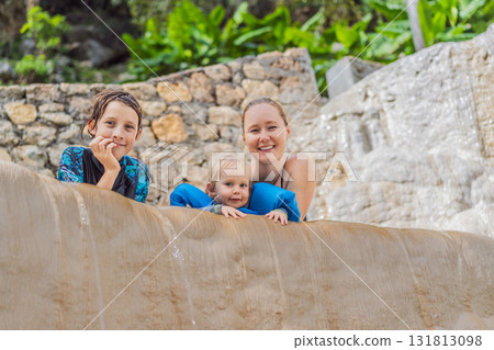 Mother with her toddler and teenage son bathing in the hot springs of Grutas Tolantongo, Mexico, enjoying family bonding, wellness, and outdoor adventure concept. Mother with her toddler and teenage son bathing in the hot springs of Grutas Tolantongo, Mexico, enjoying family bonding, wellness, and outdoor adventure concept. 131813098