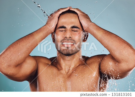 Man, water splash and face wash for skincare hygiene, hydration or shower against studio background. Young male model in beauty, wellness and washing or cleansing for clean facial body care treatment 131813101
