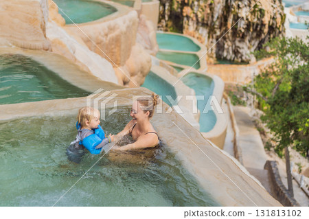 Mother and her toddler bathing in the hot springs of Grutas Tolantongo, Mexico, enjoying family bonding, wellness, and outdoor adventure concept 131813102