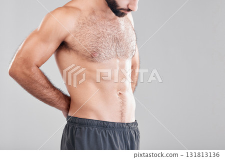 Insecurity, shirtless and man looking at body while isolated on grey studio background with mockup. Fitness, abs and topless model insecure about weight, stomach and waistline with space on backdrop Insecurity, shirtless and man looking at body while isolated on grey studio background with mockup. Fitness, abs and topless model insecure about weight, stomach and waistline with space on backdrop 131813136