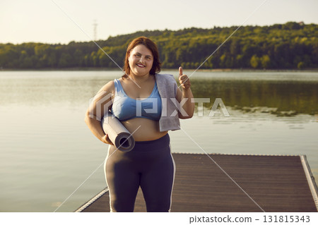 Fat woman in sportswear showing thumb up sign celebrating success in workout outdoors Fat woman in sportswear showing thumb up sign celebrating success in workout outdoors 131815343