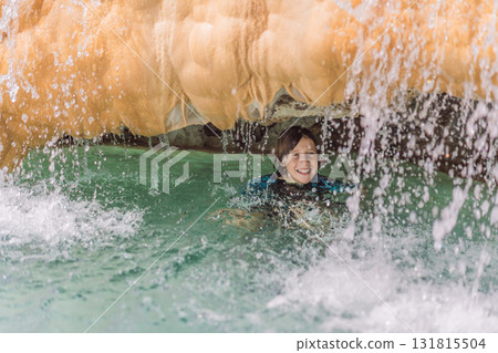 Young boy tourist bathing in the hot springs of Grutas Tolantongo, Mexico, enjoying wellness, outdoor adventure, and natural geothermal pools Young boy tourist bathing in the hot springs of Grutas Tolantongo, Mexico, enjoying wellness, outdoor adventure, and natural geothermal pools 131815504