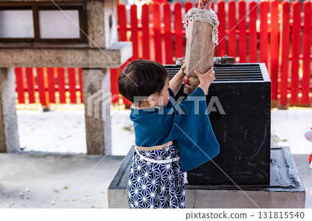 Boy ringing the shrine bell 131815540
