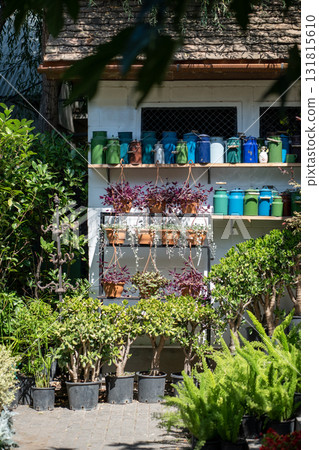 Small shop selling plants in open air. Cozy flower shop trading decorative fresh flowers in pots. Small shop selling plants in open air. Cozy flower shop trading decorative fresh flowers in pots. 131815610