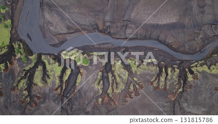 Fiji, Tana Island: Winding river flowing through volcanic terrain in Port Resolution. Wild nature landscape travel background. Drone flight aerial top down view 131815786
