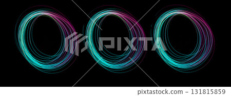 Three swirling circles of colorful light created using freeze light, capturing movement and energy in a dark setting 131815859