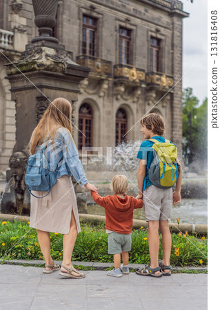 Mother with her two sons standing near Chapultepec Castle in Mexico City, enjoying sightseeing and family travel. Cultural heritage and tourism concept 131816408