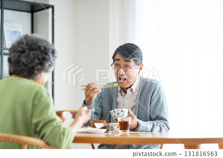 Senior couple having breakfast at home 131816563