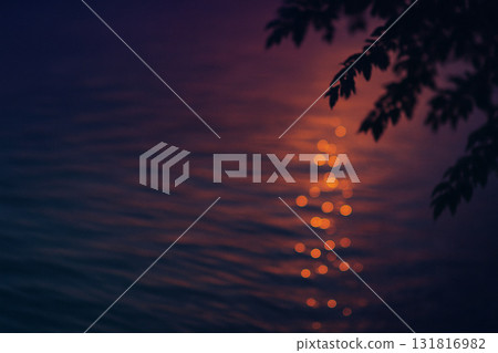 Sun glitter and quiet ripples at dusk 131816982