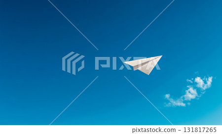 A paper airplane flying in the blue sky symbolizes freedom and a journey into the future. 131817265