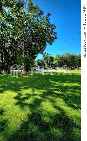Sunny park lawn with a large distant monument. Sunny park lawn with a large distant monument. 131817497