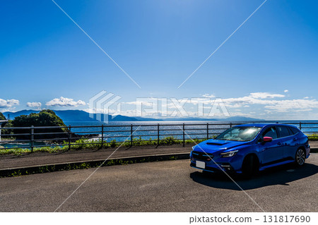 A blue car parked in a parking space by the sea. Autumn, October, Hokkaido A blue car parked in a parking space by the sea. Autumn, October, Hokkaido 131817690