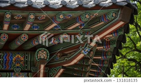 Intricate Korean traditional dancheong painted wooden brackets and eaves of historic Buddhist temple architecture with colorful floral patterns 131818135