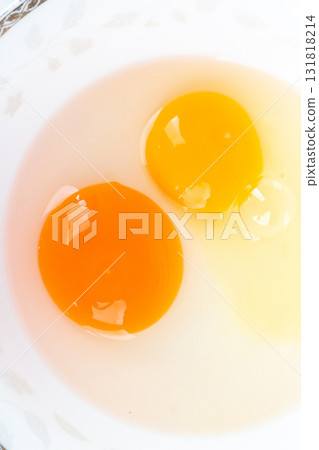 Duck egg yolk and chicken egg yolk together in one bowl on white background Duck egg yolk and chicken egg yolk together in one bowl on white background 131818214