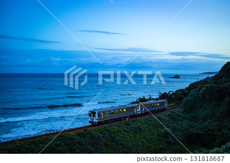 The first diesel train under the blue sky and sea at dawn The first diesel train under the blue sky and sea at dawn 131818687