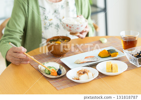 Senior woman eating breakfast Senior woman eating breakfast 131818787