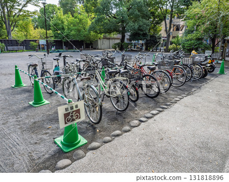 A sign indicating a bicycle parking space and a bicycle A sign indicating a bicycle parking space and a bicycle 131818896