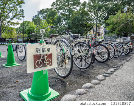 A sign indicating a bicycle parking space and a bicycle A sign indicating a bicycle parking space and a bicycle 131818897