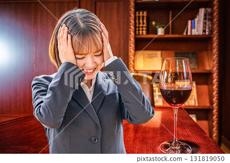 Businesswoman holding wine and head 131819050