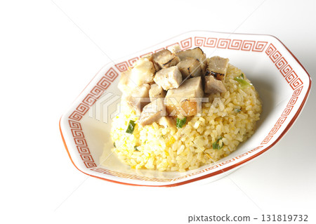 Egg fried rice topped with diced pork slices photographed against a white background Egg fried rice topped with diced pork slices photographed against a white background 131819732