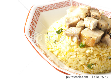 Egg fried rice topped with diced pork slices photographed against a white background Egg fried rice topped with diced pork slices photographed against a white background 131819737