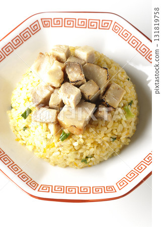 Egg fried rice topped with diced pork slices photographed against a white background Egg fried rice topped with diced pork slices photographed against a white background 131819758