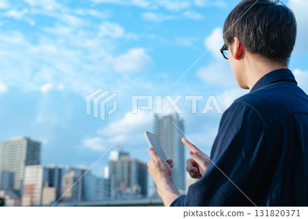 A man operating a smartphone 131820371