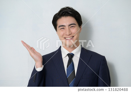 A man posing to introduce on a white background A man posing to introduce on a white background 131820488