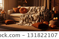 Cozy Halloween Living Room with Sofa Ghost Patterned Blanket and Pumpkins Soft Warm Lighting 131822107