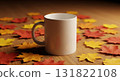 White Mug Centered Amidst Autumn Leaves on Wooden Surface Background 131822108