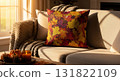 Fall Themed Pillow on Neutral Couch with Sunlight and Window Light with Pumpkins and Candle 131822109