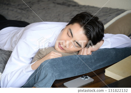 A man taking a nap face down in bed 131822132