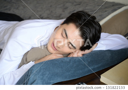 A man taking a nap face down in bed 131822133
