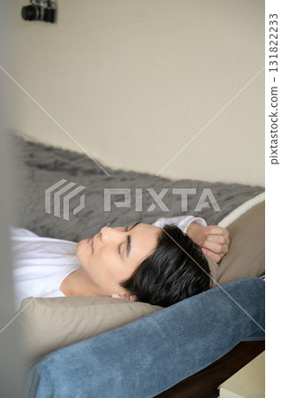 Man taking a nap in bed 131822233