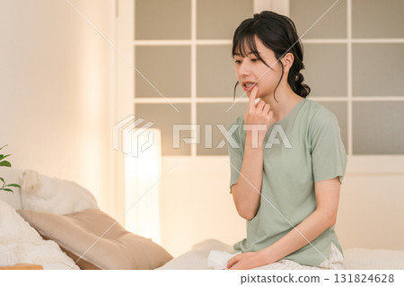Asian woman suffering from chapped lips, herpes and mouth ulcers Asian woman suffering from chapped lips, herpes and mouth ulcers 131824628