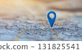 Bright blue location marker standing out on a detailed city map during golden hour 131825541