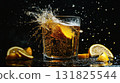 Refreshing drink with lemon slices splashing in a glass against a dark background 131825544