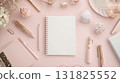Elegant workspace setup featuring stationary and decorative elements on a soft pink background 131825552