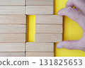 Top view of hand pulling wooden blocks with customizable space for team. 131825653