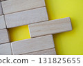 Top view of wooden blocks on yellow cover with customizable space for text. 131825655