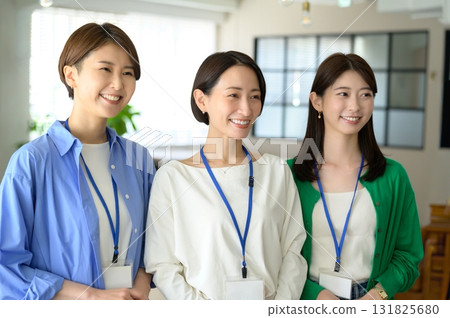 Three women lined up with nameplates 131825680