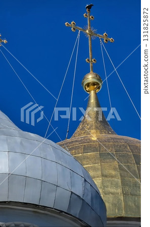 Close-up view of two large, bulbous cathedral domes against a brilliant blue sky. 131825872