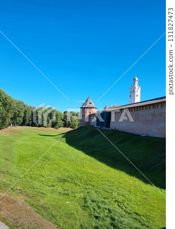 Ancient brick Kremlin wall overlooking a deep green fortress moat Ancient brick Kremlin wall overlooking a deep green fortress moat 131827473