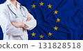 Doctor with crossed arms on European Union flag. European Union health and care concept. Female doctor on European Union flag 131828518