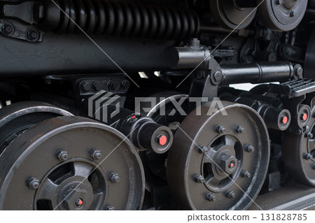 Detailed view of industrial machine gears and wheels in an engineering workshop showcasing intricate mechanics and design elements Detailed view of industrial machine gears and wheels in an engineering workshop showcasing intricate mechanics and design elements 131828785