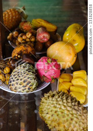 Exotic fruit display at a local market in Southeast Asia showcasing vibrant colors and unique varieties during the afternoon Exotic fruit display at a local market in Southeast Asia showcasing vibrant colors and unique varieties during the afternoon 131828858