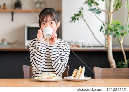 Girls drinking milk, hot milk, soup, juice, coffee for breakfast, lunch Girls drinking milk, hot milk, soup, juice, coffee for breakfast, lunch 131829515
