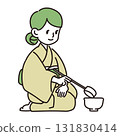 A woman using a ladle in a tea ceremony 131830414